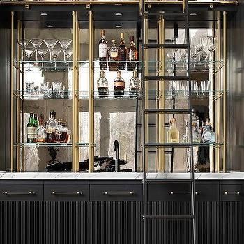 Black Reeded Cabinets with Black Ladder on Rails - Transitional - Kitchen Bar With Brass Railing, Mirrored Backsplash, White Kitchen Pantry, Black And White Flooring, Grey Shelves, White Accent Chair, Bar Shelves, Pantry Cabinets, Mirror Backsplash