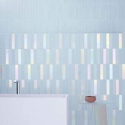 The Spectre Nemo Glow Mix 2" x 10" Subway Wall Tile Collection by 41zero42(Italy). A masterpiece of light and color that brings your walls to life. Spectre Nemo Glow is the culmination of a deep exploration into how light interacts with tile glazes. After extensive research, 41zero42 developed the Hologram finish, a glossy surface that changes color as light shifts, creating a dynamic, iridescent effect. Available in a versatile 2" x 10" (5x25 cm) size, Spectre Nemo Glow comes in four refined co Iridescent Pool Tile, Holographic Tiles, Mermaid Inspired Bathroom, Iridescent Tile Bathroom, Entryway Tile Floor, Tile Wainscoting, Modern Shower Tile, Iridescent Tiles, 70s Bathroom