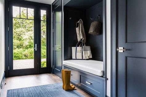 Dark blue mudroom features a dark blue built in bench fitted with drawers placed under a dark blue backsplash lined with hooks flanked by dark blue closet doors. Contemporary Laundry Room, Blue Laundry Rooms, Mudroom Cabinets, Ideas Closet, Entryway Closet, Mudroom Entryway, Blue Backsplash, Mudroom Design, Boot Room