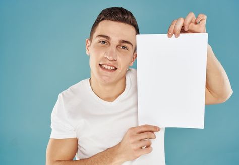 Young man holding a sheet of paper with ... | Premium Photo #Freepik #photo #holding-sign #holding-banner #holding-paper #business-executive Person Holding Paper Reference, Person Holding Sign, Man Holding Paper, Mtn Logo, Holding A Piece Of Paper, Holding Sign, Holding Paper, Man Pictures, Holding A Sign