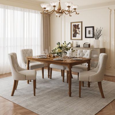 Add some warmth and elegance to your dining room with this beige linen dining chair. This elegant, classic upholstered leisure chair is comfy and sturdy, and it goes great with your living and dining room. It has a standard size of 22.5" x 25" x 35.75", so it fits most tables and spaces. The seat cushion is filled with springy foam, so you can relax and sit back in comfort. The back of the chair has a diamond-shaped tufted design that feels soft and luxurious. The edges and arms are adorned with Bar Height Dining Table, Linen Dining Chairs, Brown Armchair, Tufted Dining Chairs, Stone Dining Table, Counter Height Dining Table, Pedestal Dining Table, Living And Dining Room, Upholstered Fabric