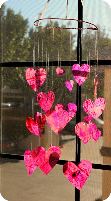 Here’s a fun diy project to do together with your kids for Valentine’s Day.  The cut-out hearts are simply crayon shavings melted in between layers of waxed paper.  The colors are beaut… Wax Paper Crafts, Heart Mobile, Cadeau St Valentin, Stained Glass Heart, Holiday Art Projects, Diy Newspaper, Diy Crayons, Crafting Corner, Crayon Heart