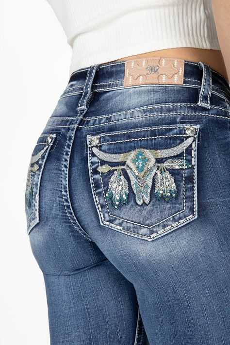 -Mid-rise, medium wash bootcut denim-Embroidered longhorn with Aztec print on back pockets-White, beige and turquoise stitching-Silver sequins and turquoise bead rivet-Rhinestone rivets-Light Pink brand patch with white Aztec embroidery-Fading-Front Rise: 9", Back Rise: 14"-Inseam: 34"-73% Cotton, 24% Viscose, 3% Elastane-Gentle machine wash with like colors in cold water, Tumble dry low Model is wearing size: 25Model Measurements: Height: 5'9" Bust: 34" Waist: 24" Hips: 34" Style No. M9187B-M89 Boot Cut Jeans Cowgirl, Pure Western Jeans, Cow Girl Jeans, Embroidered Bootcut Jeans, Gem Jeans, Longhorn Design, Cowgirl Pants, Jean Embroidery, Cute Western Outfits