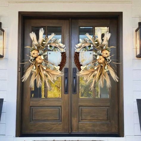 This beautiful fall wreath will be the perfect touch for your door, double doors, columns, wall, etc. Wreath is made on a grapevine base and packed full of quality faux pampas, lambs ear, natural pumpkins and more. Shown in the 18" grapevine base. The blue door is 35" wide. Double door wreaths will be made mirrored.  14" base Dimensions: Wreath grapevine base 14" Height approx 28" Width approx 22" Depth approx 8" 18" base Dimensions: Wreath grapevine base 18" Height approx 34" Width approx 26" D Fall Double Door Wreaths, Double Door Fall Wreaths, Barn Door Decor, Magnolia Decor, Fall Front Door Decor, Faux Pampas, Double Door Wreaths, Wreath Pumpkin, Fall Grapevine Wreaths