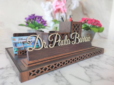 My goal is to design and produce different products. Custom design All-duty Desk Name Plate is made for those looking for something different. Table name plate with Business Card Holder and pen holder It puts an end to the complexity of your desk and allows you to keep your desk organized. Perfect gift for Doctor, Teacher, Realtor, Manager and many more professions. Make your name and title stand out with a special nameplate. Our product is made of 1st class MDF material. Doctor Sign, Name Blocks, Table Name, Desk Name Plate, Desk Name, Desk Name Plates, Table Names, Teacher Name, Business Card Holder