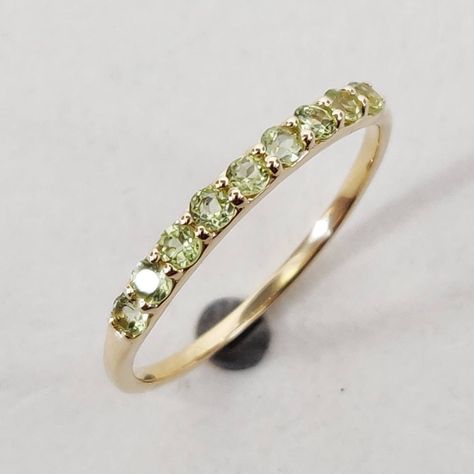 This stunning ring is set in 14k Solid Yellow Gold with Natural Peridot with utmost precision. It is an unique statement gemstone ring for nearly every occasion and is completely hassle-free jewelry. ITEM DETAILS: * GEM: Peridot * GEM SIZE: 2mm * GEM SHAPE: Round 9pcs * Gem weight: 0.29 carats * Gold Purity: 14KT * Gold Weight: 0.87 gram * Total Weight of the Ring: 0.93 gram The Gold purity is guaranteed and it comes with an authentic 14KT gold hallmark. Since my items are handmade, they are abs Yellow Gold Peridot Diamond Ring With Birthstone, Gold Peridot Ring For May Birthstone, Yellow Gold Peridot Stackable Rings For Wedding, Yellow Gold Peridot Birthstone Ring, Yellow Gold Peridot Stackable Rings, Peridot Engagement Rings, Handmade Jewelry Box, Peridot Stone, Half Eternity Ring