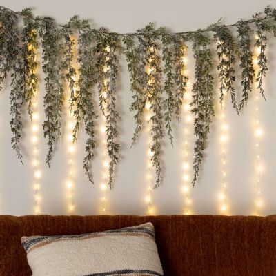 This exclusive curtain light from Sullivan's home decor casts a warm, inviting glow that's perfect for indoors or outdoors. The versatile design allows you to drape the light cord over curtains, railings, or banisters to softly illuminate any space with a stylish aesthetic. Whether you want to create a magical glow for your Christmas decor or add a subtle accent to your living room, this curtain light delivers a warm, welcoming ambiance that's perfect for any occasion. The Holiday Aisle® | The H Cypress Garland, Stair Railings, Curtain String Lights, Pine Garland, Unique Christmas Decorations, Holiday Christmas Tree, Curtain Lights, White Curtains, Fireplace Mantle