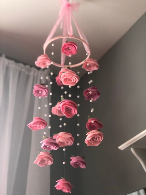 "Handmade felt roses and pearls baby nursery mobile or kids room hanging decor. 8\" circumference, 36\" length. Mixed pinks (pixie pink, raspberry sorbet, pink) as shown or choose your own colors. And because I feel obligated to say this: This is NOT a toy and should never be reachable by a child. Small pieces, and wire is dangerous. All my mobiles are 100% customizable to your liking. Just message me and we will build YOUR perfect mobile. Ribbon, color, size, additions, removals....all is possi Rose Themed Nursery, Pink Baby Room Decor, Flower Mobiles, Pink Room Decor Aesthetic, Stevie Bell, Felt Flower Mobile, Pretty Nursery, Nursery Hanging Decor, Cardboard Art Sculpture