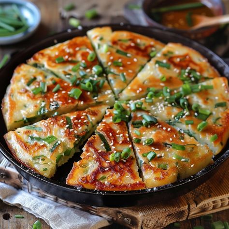 🥞 Enjoy the savory Pajeon (Green Onion Pancake)! 🌿✨ #Pajeon #KoreanPancake Pajeon (Green Onion Pancake) Ingredients: All-purpose flour (1 cup) Cold water (1 cup) Egg (1) Green onions, cut into 2-inch pieces (1 cup) Seafood mix (optional) (1/2 cup) Soy sauce (2 tbsp) Sesame oil (1 tbsp) Vegetable oil (for frying) Dipping sauce (soy sauce, vinegar, sesame seeds) Instructions: In a bowl, mix flour, water, egg, and soy sauce to form a batter. Stir in green onions and seafood mix (if using). H... Pancake Ingredients, Green Onion Pancake, Onion Pancake, Big Snacks, Korean Pancake, Seafood Mix, Instagram Recipes, Twisted Recipes, Savory Pancakes