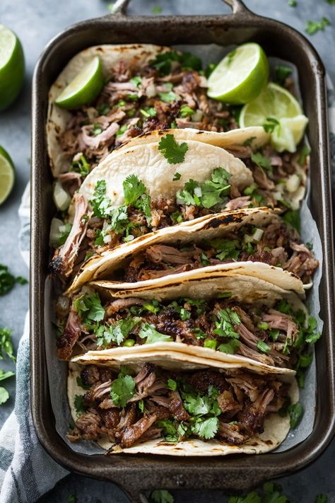 Tacos filled with shredded meat, cilantro, and lime wedges. Pork Tacos Crockpot Carnitas, Carnitas Street Tacos, Pork Tacos Crockpot, Tacos Crockpot, Crockpot Carnitas, Instant Pot Carnitas, Tips For Meal Prepping, Zucchini Lasagna Rolls, Carnitas Tacos