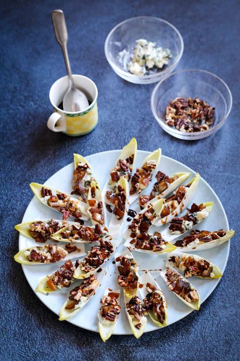 Blue cheese and pecan endive appetizer on serving plate with bowls of blue cheese and pecans in background Endive Cups, Blue Cheese Appetizers, Endive Appetizers, Creamy Balsamic Vinaigrette, Chopped Dates, Belgian Endive, Baked Appetizers, Roquefort Cheese, Pecan Salad