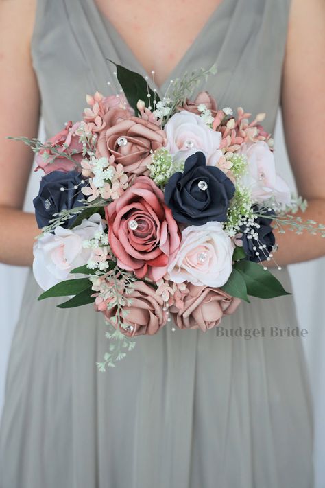 This is a unique cascading bouquet made with dusty rose-colored roses, navy blue, mauve roses accented with pale pink roses. This beautiful bouquet can be made in any color. We custom design and make brides bouquets in colors that will match your bridesmaids dresses from Azazie and Davids Bridal Mauve Wedding Decorations, Bouquet Stand, Mauve Roses, Blue And Blush Wedding, Cascading Bouquet, Colored Roses, Red Bouquet Wedding, Mauve Wedding, Pale Pink Roses