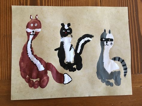 Woodland Animal Hand and Foot Print Art. A fox, a skunk and a raccoon. Woodland Animal Handprint Art, Skunk Footprint Craft, Raccoon Handprint Craft, Woodland Footprint Art, Hand And Foot Print Art, Skunk Craft, Handprint Canvas, Handprint Alphabet, Melody Room