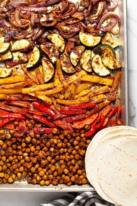 These quick and easy vegan Sheet Pan Chickpea Fajitas are a delicious weeknight dinner that comes together in under 30 minutes. Loaded with chickpeas, peppers, onions, and zucchini along with a signature fajita seasoning - this simple dinner will quickly become a family favorite. Chickpea Fajitas, Healthy Sheet Pan Dinners, Vegetarian Fajitas, Vegan Fajitas, Healthy Sheet Pan, One Pan Dinner Recipes, Vegetarian Stuffed Peppers, Chickpea Tacos, Dinners To Make