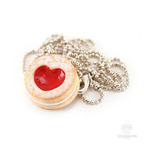 Size: 18 inch silver plated ballchain, heart cookie is 5/8" wideMaterial: Polymer clay, gloss, silver plated findingsSmells like: Strawberry shortcake cookies Is food the language of love? If so, this adorable Scented Shortcake Heart Cookie Necklace speaks volumes! Forget the symbolism of a single red rose, this tiny cookie charm expresses romantic intention perfectly. Sweetened with a generous dusting of icing sugar, the sweet jam-filled center has been sculpted to form a beautiful heart – idea Shortcake Cookies, Strawberry Shortcake Cookies, Single Red Rose, Heart Cookie, Delicious Clean Eating, Heart Shaped Cookies, Food Patterns, Heart Cookies, Tiny Hand