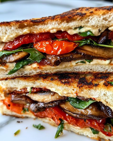 Grilled Veggie & Houmous Sandwich 🥪🌿 Happy national sandwich day! Follow @plantiful.palate for more recipes🗒️ Ingredients: • 2 slices of sourdough bread • 1/4 cup hummus • 1/2 cup cherry tomatoes, halved • 1/2 cup mushrooms, sliced • Handful of fresh spinach or arugula • Olive oil for grilling • Salt and pepper to taste Method: 1. Preheat a pan over medium heat with a drizzle of olive oil. Add the sliced mushrooms and cherry tomatoes. Sauté for 5-7 minutes until the mushrooms are... National Sandwich Day, Mushroom Sandwich, Sandwich Day, Fried Tomatoes, Sourdough Sandwich, Flat Breads, Grilled Mushrooms, Veggie Sandwich, Fresh Spinach