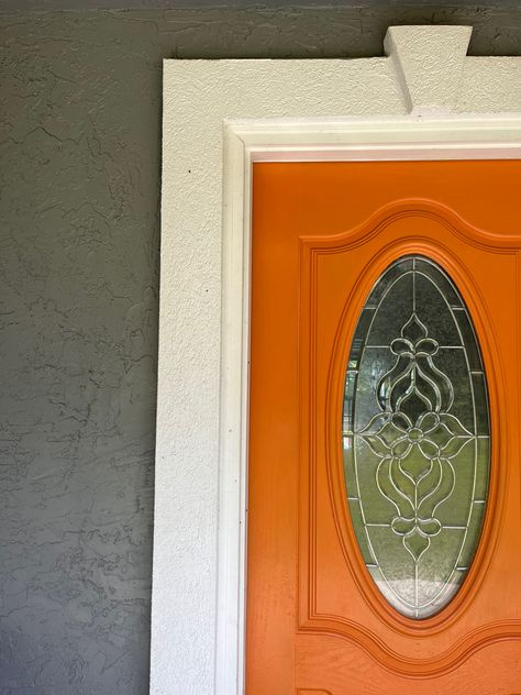 Sherwin Williams Amber Wave Orange front door against a grey stucco exterior. Make your front door pop with fun bright colors! Grey Stucco Exterior, Gray Stucco Exterior, Grey Stucco, Orange Front Door, Orange Front Doors, Tan House, Orange Door, Beautiful Entryways, Grey House