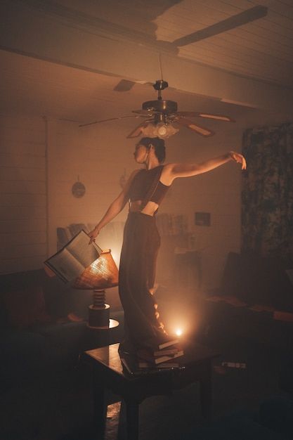 Person Sitting With Legs Dangling, Someone Holding A Book, Poses Holding Something, Young Woman Aesthetic, Person Holding Book, Dancing On Table, Woman Holding Book, Book Woman, Table Photography