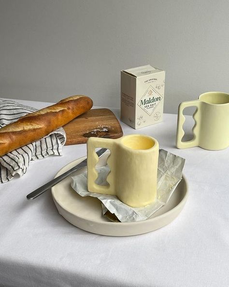 RACHEL SAUNDERS on Instagram: "Our Butter glaze has really carved out a place in our hearts and we just had to bring it back. Full restock of all your favourites now online :~) Celebrating with our other favourite sculptural medium, grass fed butter. Here’s our Ettore Mug expertly crafted by @alyxandra.savage 🧈 Mug, Cups, Bowls and more now online 🏺" Mug Cups, Butter Glaze, Affordable Aesthetic, Bring It Back, Grass Fed Butter, Aesthetic Home, Home Items, Scented Candles, Glaze