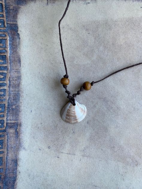 Handmade sea shell necklace crafted with brown hemp cord and brown wooden beads. Necklace With Shells Diy, Sea Shell Necklace Men, Homemade Shell Necklace, Shell Necklace Tutorial, Marine Crafts, Shell Necklace Diy, Homemade Beads, Homemade Necklaces, Sea Shell Necklace