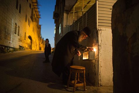 An ultra-orthodox Jewish man lights candles on the sixth night of the Jewish holiday of Hanukkah, in a religious neighbourhood of Jerusalem History Of Hanukkah, Jewish Men, Pictures Of The Week, Night Photos, Festival Lights, Top Photo, Small World, Beautiful World, Amazing Photography