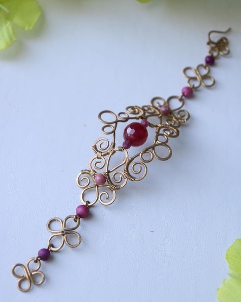 This bracelet is fully handmade, made with brass wire and ruby and rhodochrosite crystals. I really enjoy making woven designs like this, whether it’s earrings or bracelets! She’s available and listed on my website!😊 • • • • • #wirewrapbracelet #handmadewirejewelry #wirebracelet #crystaljewelry #wirewrappedjewelry #wirewrapping #brasswirejewelry #handmadebracelets #brassjewelry #crystalwirewrapping #brassbracelet #crystalbracelets #rubyjewelry #brasswire #crystalbracelet Wire Wrapped Bead Bracelet, Wire Bracelet Tutorial, Wire Cuff Bracelet, Wire Jewelry Patterns, Wire Wrap Jewelry Designs, Crystal Bead Jewelry, Wire Wrapped Jewelry Diy, Wire Bracelets, Wire Jewelry Designs