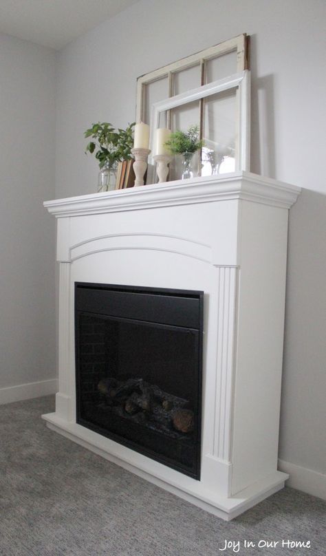 An electric fireplace gets a new lease on life. This stunning FAT Paint transformation, by Kendra at Joy in Our Home, FAT Paint’d in Chalk White. It certainly brightens up a dark basement. Farmhouse Fireplace Makeover, Fireplaces Makeover Modern, Craftsman Remodel, Industrial Farmhouse Decor, Fake Fireplace, Fireplace Cover, Fireplace Shelves, Shiplap Fireplace, Terrace Decor