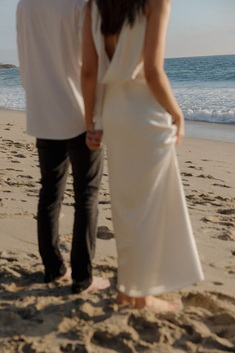 Bride and groom walk in the sand toward the beach in beach elopement photos. Beach Elopement Aesthetic, Elopement Dress Beach, Beach Elopement Dress, Thousand Steps Beach, Wedding Photos Beach, Elopement Beach, San Diego Elopement, Beach Engagement Photoshoot, Beach Wedding Photos