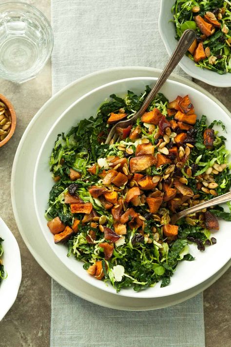 This roasted sweet potato, apple and kale salad features lots of fall flavors thanks to cinnamon and maple roasted sweet potatoes and apples, shredded Brussel sprouts, dried cherries, toasted pumpkin seeds and an apple butter and maple vinaigrette. Sweet Potato And Kale Salad, Kale Sweet Potato Salad, Apple Dressing, Sweet Potatoes And Apples, Potatoes And Apples, Potato Salad With Apples, Sweet Potato And Kale, Sweet Pumpkin Seeds, Sweet Potato Apple