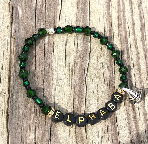 Elphaba, The Green Witch from Broadway's Wildly Popular "Wicked" The Musical! A little silver witch's hat so "smart" hat Charm!  If you would like one that reads "Elphie" please message us and we will happily make the same design with her name that way for you! Thank you!  Share and remember each moment! The perfect gift to compliment tickets to a show, a gift for a fan to enjoy, or a celebration of an upcoming performance by a friend in a show! So many reasons to Share, Sparkle and SHINE!  A po Popular Wicked, Wicked Outfit, Elphaba Wicked, Wicked Elphaba, Wicked Broadway, The Green Witch, Bracelets Inspiration, Wicked The Musical, Charm Beaded Bracelet