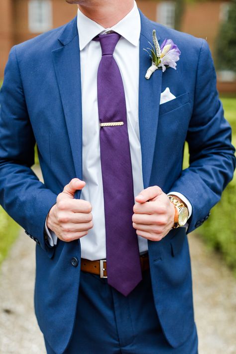 Suit: Mens Wearhouse  Tie: Mens Wearhouse  Belt: Mens Wearhouse Watch: Zumiez Florals: Gabriela Creations  #groom #groomsuit #weddingsuit #navyand purple wedding #bluesuits #wedding #weddingday #rainydaywedding #groomsmen Blue And Purple Groom Suit, Blue And Purple Suit Men, Navy Suit With Purple Tie, Purple And Blue Suit, Blue Suit Purple Tie Wedding, Navy Blue Suit Purple Tie, Blue And Purple Tuxedo Wedding, Blue And Purple Groomsmen Attire, Tangled Wedding Groom