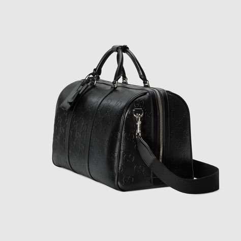 Shop the GG embossed duffle bag at GUCCI.COM. Enjoy Free Shipping and Complimentary Gift Wrapping. Luxury Elegant Men's Duffle Bag, Functional Black Leather Duffle Bag, Luxury Leather Duffle Bag For On-the-go, Luxury Black Smooth Grain Duffle Bag, Black Leather Duffle Bag For On-the-go, Bags For Men, Bags Gucci, Duffle Bags, Metal Engraving