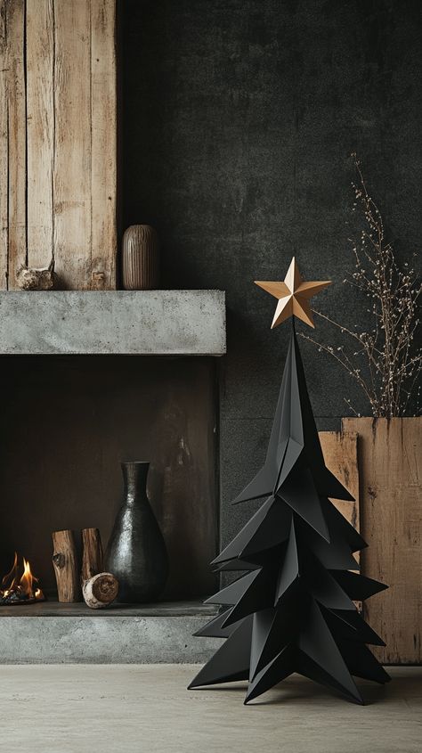 Minimalist black origami Christmas tree in front of a fireplace, with vases and a wooden star, against a dark concrete wall. Black Wooden Christmas Tree, All Black Christmas Decor, Gray Christmas Tree Decor, Modern Black Christmas Tree, Black And White Christmas Aesthetic, Black Xmas Tree Decorating Ideas, Masculine Christmas Tree, Wabi Sabi Christmas, Minimalistic Christmas Decor