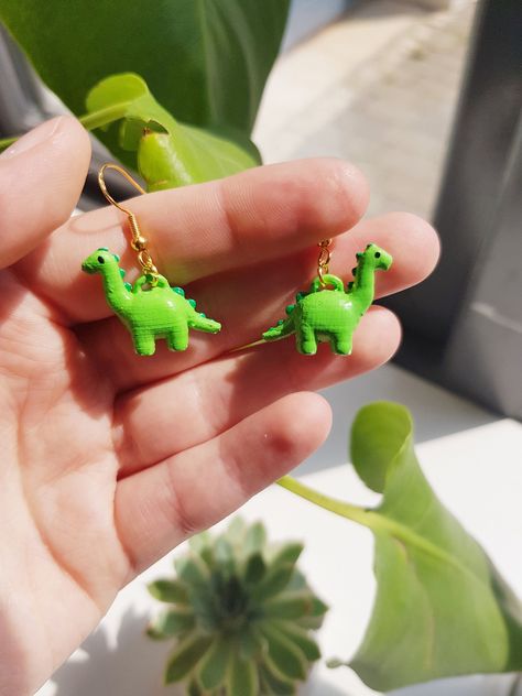 Cute Dino Dangle Earrings All items are made to order, so feel free to request a colour! Earring requests are open if you want something different, message me if you want to know more! Silly Earrings, Crazy Earrings, Cute Dino, Weird Jewelry, Diy Earrings Polymer Clay, Dinosaur Earrings, Tanah Liat, Quirky Earrings, Food Earrings