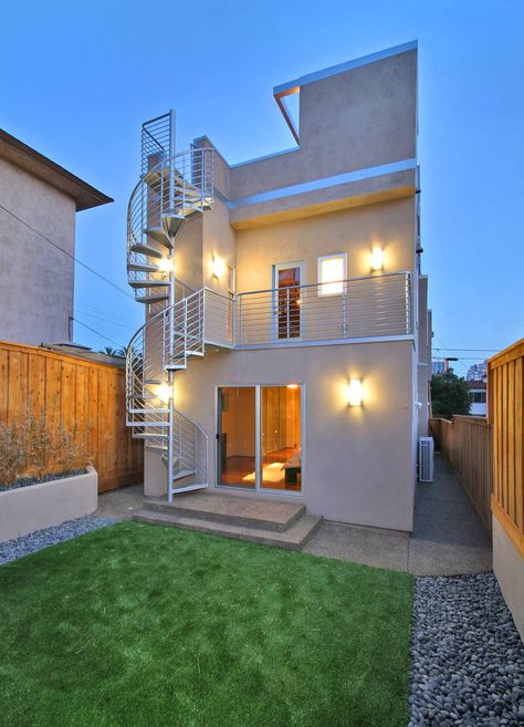 The exterior of this contemporary showcase in an urban environment balances ultra clean lines with bold lighting for a powerful presentation of modern design. http://www.jacksondesignandremodeling.com/curb-appeal-remodeling/modern-dazzle Spiral Staircase Outdoor, Lush Backyard, درج السلم, Staircase Outdoor, Spiral Staircases, Contemporary House Exterior, Exterior Stairs, Urban Contemporary, Contemporary Exterior