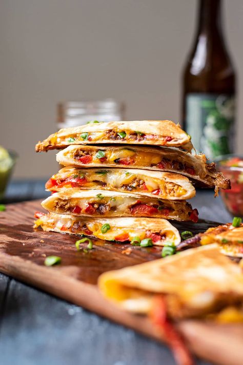 These pulled pork quesadillas are made with layers of roasted peppers and red onions, Monterey jack cheese, seasoned pulled pork, and green onions. They're cheesy, creamy, and a little smokey thanks to the pork seasoning and seared veggies. All you need are a few sides of sour cream, chunky salsa, and homemade guacamole for a delicious meal or sharable app. #quesadillas #mexicanrecipes #pulledporkquesadillas Pork Quesadilla Recipes, Pulled Pork Quesadillas, Pork Quesadillas, Kitchen Swagger, Pork Quesadilla, Pulled Pork Quesadilla, Pork Carnitas Tacos, Pork Seasoning, Pulled Pork Leftovers