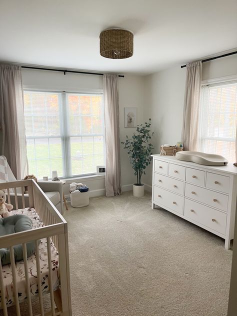 Nursery Room Side Table, Nursery With Light Wood Crib, Curtains For Nursery Neutral, Nursery Room Bookshelf Ideas, Nursery With Windows On Two Walls, Natural Baby Boy Nursery, Crib In Front Of Window Nursery, Changing Table In Front Of Window, Neutral Gray Nursery