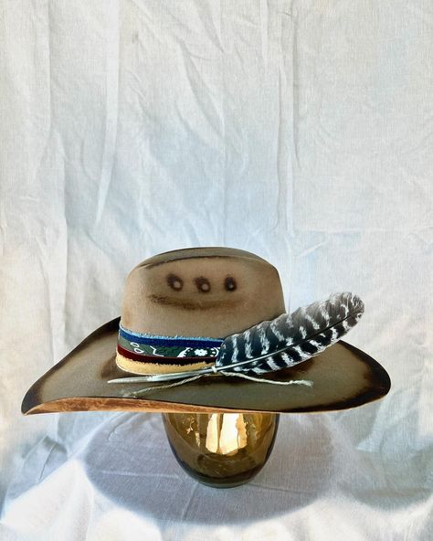 “Rambler” Custom burned and banded chestnut brown cowboy hat adorned with hand sewn details, denim, twine, multiple fabrics and a turkey feather. Very good quality cashmere wool felt hat. One of a kind. Size 6 7/8 $275 https://theroguecowpoke.etsy.com/listing/1807969623 Brown Fedora With Feathers For Western-themed Events, Brown Ranch Hat With Feathers, Feathered Flat Brim Felt Hat For Western-themed Events, Western-themed Felt Hat With Feathers And Flat Brim, Western-themed Fedora Hat With Feathers, Brown Cowboy Hat, Turkey Feathers, Chestnut Brown, Cashmere Wool