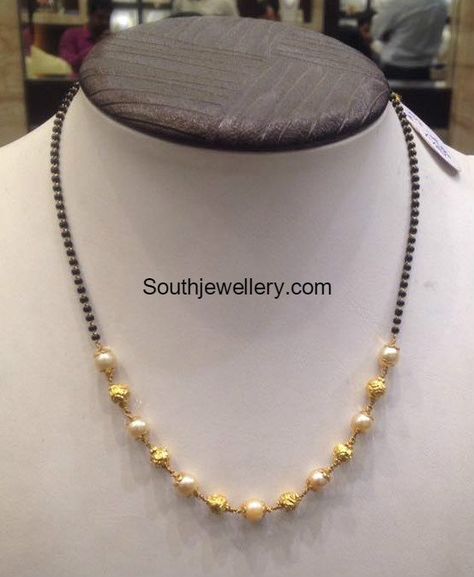 22 carat gold light weight short mangalsutra chain strung with black beads, south sea pearls and Nakshi balls. For inquiries contact on Whatsapp: +91 97 00 009000 or Email: dharmesh25@yahoo.com Related PostsLight Weight Ruby South Sea Pearl NecklaceTwo Line Black Beads Mangalsutra with Diamond PendantLight Weight Black Beads Mangalsutra ChainsMulti Strand Short Nallapusalu ChainsLight Weight Short Nallapusalu, Nakshi Balls, Short Mangalsutra, Mangalsutra Chain, Black Beads Mangalsutra, Gold Jewelry Outfits, Black Beads Mangalsutra Design, Vijay Devarakonda, Gold Earrings Wedding