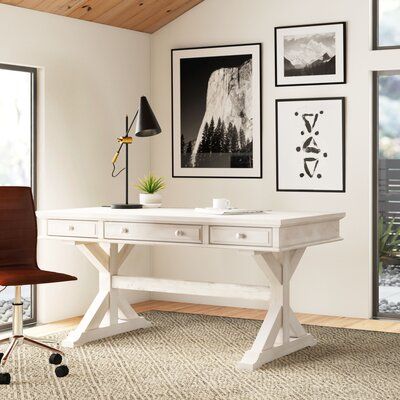 Whether you’re setting up your home office or searching for the perfect DIY space, this desk offers ample space to spread out *and* opportunities for out-of-sight storage as well. Crafted from solid rubberwood, the top of this writing desk strikes a rectangular silhouette that’s set on a canyon base. Offering 2 small drawers on either side of the center keyboard tray, each of the 3 is set on full-extension ball-bearing drawer glides for soft opens and closes. Plus, it comes complete with cable m