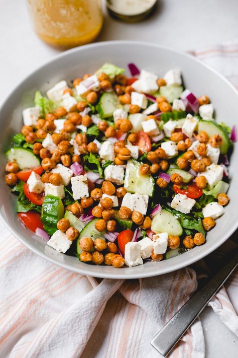 Quickly roast up a can of garbanzo beans for a toasty roasted chickpea Greek salad, tossed with a homemade vinaigrette. Roasted Greek Salad, Chickpea Greek Salad, Fried Chicken Salads, Roasted Chickpea Salad, Roasted Garbanzo Beans, Crispy Chicken Salads, Garbanzo Beans Salad, Good Fried Chicken, Chickpea Recipes Roasted