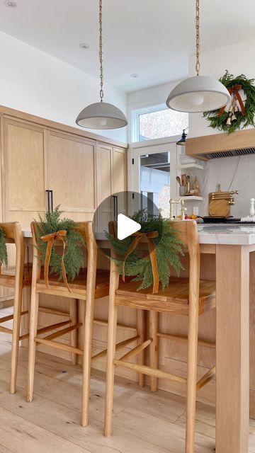 Kasey Dixon on Instagram: "HOLIDAY \ Christmas chair styling with faux mini wreaths and velvet bows - both Amazon finds!✨ Here I’m showing you how I decorate using them on my kitchen barstools. I simply tie a bow with velvet ribbon and secure them to the chair using a small command sticky and hook. LOVE the festive touch in this space! They would also look great on dining chair!🌲 And no, the kiddos have not destroyed them… yet😝  Comment WREATH below to receive a DM with the link to shop this post on my LTK 🔗🔗 https://liketk.it/4WtGk   #christmaswreaths #christmaswreath #christmasdecorations #christmasdecorideas #christmasdecorating #amazonhome #amazonfinds #christmasstyle #christmasstyling" Decorate Bar Stools For Christmas, Wreath On Back Of Dining Chair, Dining Chair Christmas Decor, Bar Stool Christmas Decor, Christmas Decor For Kitchen Island, Wreath In Kitchen, Kitchen Barstools, Chair Styling, Winter Holiday Decorations