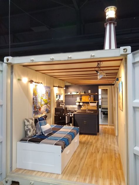 Here is a great view of a Tiny House Container. The IKEA bed has storage underneath and can be pulled out to accommodate two people. The IKEA bed is also on rollers and can be rotated to fit between the two doors. Great for stargazing when you leave the big doors open. There is a kitchenette with oven and four burners, and a double farm sink against the inside wall. At the backside of the wall is an oversized bathroom with shower and flushing toilet. It all fits in a 20ft shipping container. Tiny House Container, Container House Interior, Shipping Container Cabin, Container Conversions, Storage Container Homes, Container Cabin, Shipping Container House Plans, Container Buildings, Building A Container Home