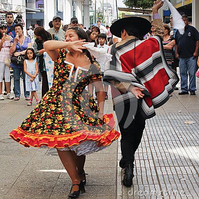 A couple dances Cueca in the streets of Concepcion, Chile. Is a family of musical styles and associated dances from Argentina, Chile and Bolivia. Vestidos tradicionales #biobio #celebration #chile #china #concepcion #costume #country #couple #cueca #culture #dance #dancers #dancing #dress #expression #folklore #hat #hispanic #huaso #latinamerica #nationalism #party #performers #poncho #southamerica #street #traditions #typical Dance Editorial, Country Couple, Cultural Dance, Dance Photo, Dancing Dress, World Dance, Traditional Dance, Couple Dancing, Costume Dress