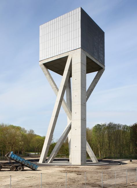 Belgian architecture studio V+ has completed a mesh-covered water tower that is supported by angled concrete columns Concrete Column, Lookout Tower, Concrete Architecture, Tower Design, Architecture Awards, Brutalist Architecture, Rain Water Collection, Watch Tower, Water Tower