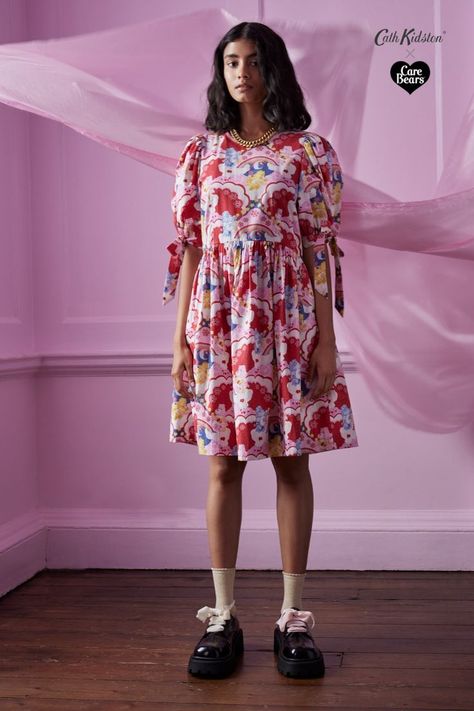 Bring a little 60s psychedelia, a little reverie, and lots of Care Bear love into your wardrobe with our limited-edition dresses featuring our hand-painted Wish Big print. Coordinate with your Little-Me in our dresses that make for the perfect treat for you or a heartfelt gift to pass on the joy. Playful Patterned Floral Print Dresses, Playful Floral Print Cotton Dress, Playful Pink Heart Print Dress, Playful Strawberry Print Summer Dress, Bear Love, Whimsical Unicorn Print Dress For Dress-up, Big Dresses, Patterned Dress, Bags Fashion