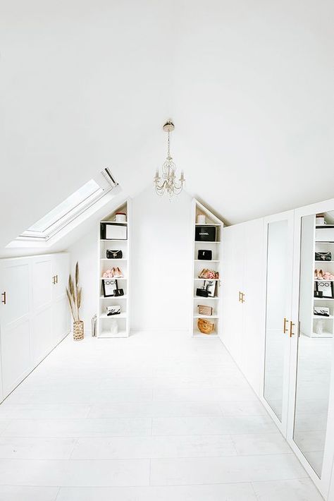 an all white attic closet with open shelves, closed storage compartments, an elegant chandelier, some decor and mirrors Loft Conversion Dressing Room, Loft Conversion Wardrobes, Small Attic Spaces, Loft Closet, Small Attic Bathroom, Loft Conversion Bedroom, House Purchase, Velux Windows, Loft Office