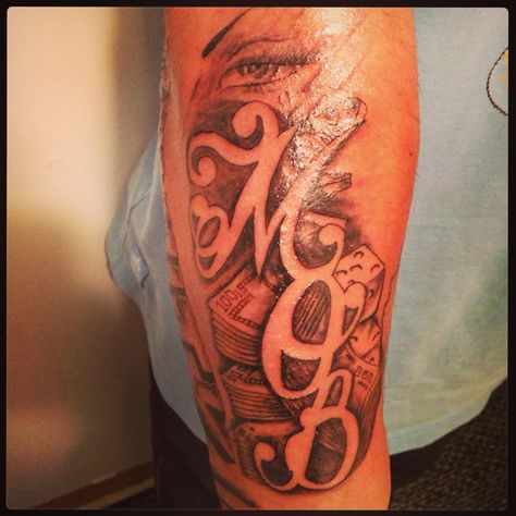 "M.O.B." (money over b!+*#'s) tattoo by Keno G Mob Tattoo For Men, M.o.b Tattoo, Mob Tattoo Design, Mob Tattoo Ideas, Mob Tattoo, Money Bag Tattoo, Bag Tattoo, Gang Tattoos, Around Arm Tattoo