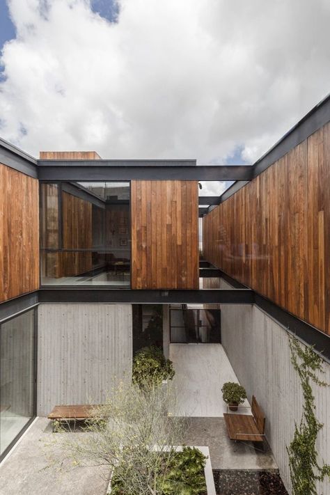 A Modern Mexican Home Rises With Vertical Timber Cladding #midcentury #modernhome #tijuanamexico #hometour Wood And Concrete Exterior, Vertical Timber Cladding, Modern Cladding, Vertical Cladding, Modern Mexican Home, Concrete Siding, Wood Siding Exterior, Wood Facade, Sleeping Quarters