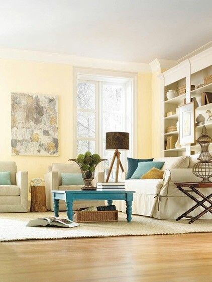 Soft yellow walls linen colors seating, with a splash of blue. Very soothing living room Pale Yellow Walls, Wire Vase, Yellow Walls Living Room, Light Browns, Apartment Walls, Yellow Room, Yellow Living Room, Neutral Background, Yellow Wall